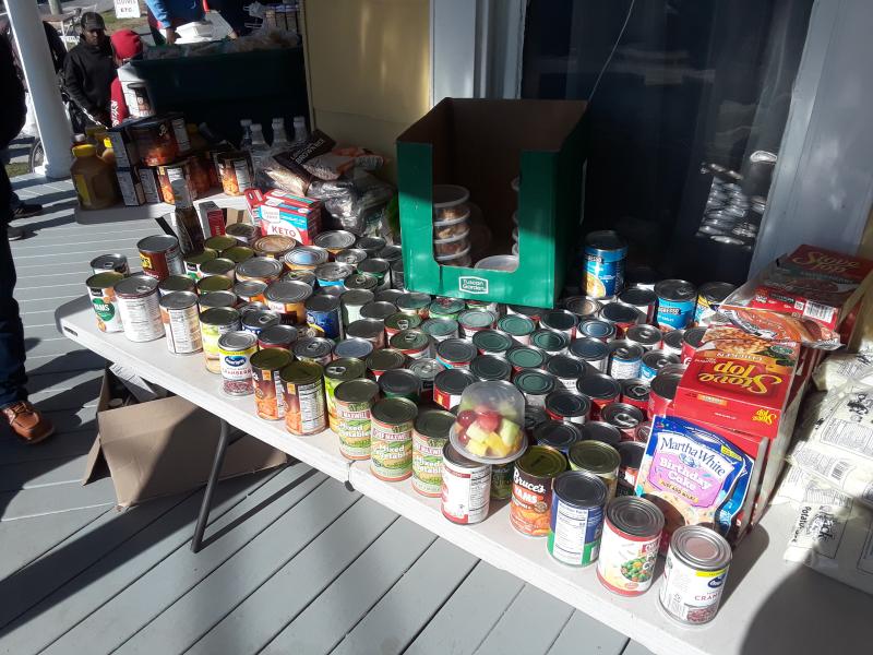 Donated canned goods sit ready for pickup on the porch on Thanksgiving Day.